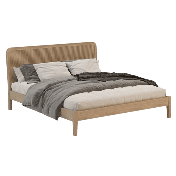 Bed dressed in layered quilts and pillows