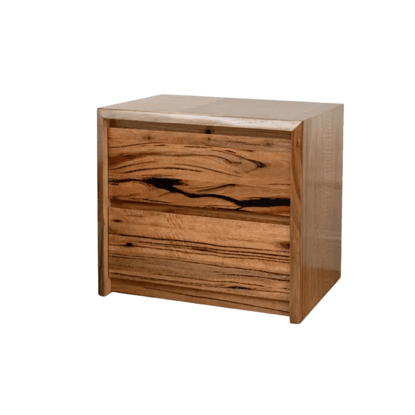 Timber bedside table beside a bed